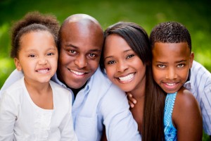 Portrait of an African American family looking very happy outdoo